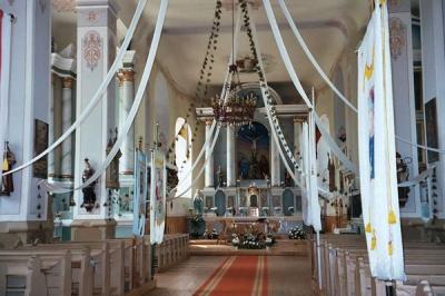 The colorful interior of the village church in Laukuva, near Varniai, Uzventis, and Silale. Most churches in Lithuania reflect the care and attention of their devout parishioners, as well as a taste for rich color and ceremony. 