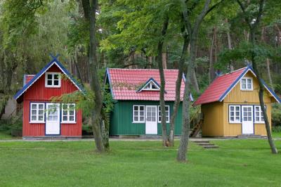 Colorful tourist cabins near Nida.  The drabness of the period of the Soviet occupation is slowly being replaced with more colorful and pleasing land- and city scapes. The colorful roots of the country can be seen in its  various regional costumes. 